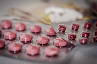 Close-up of pink and red pills in blister packs