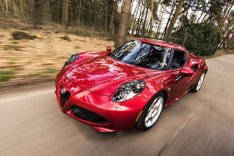 Red Alfa Romeo 4C Sports Car Driving on Forest Road