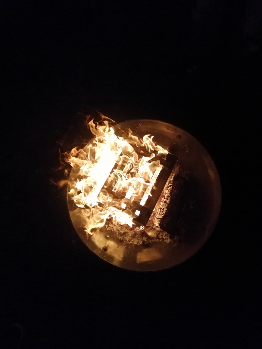 Top View of Burning Fire in Metal Fire Pit at Night