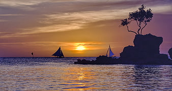 Sailboats and Rock Formation Silhouette at Sunset in Boracay, Philippines