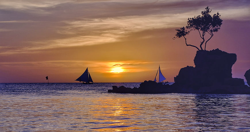 Sailboats and Rock Formation Silhouette at Sunset in Boracay, Philippines