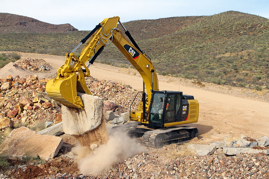 Yellow Caterpillar Excavator Breaking Rock In Desert Quarry