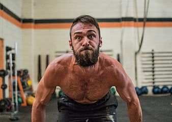 Intense Bearded Athlete Performing Push-Up In Gym