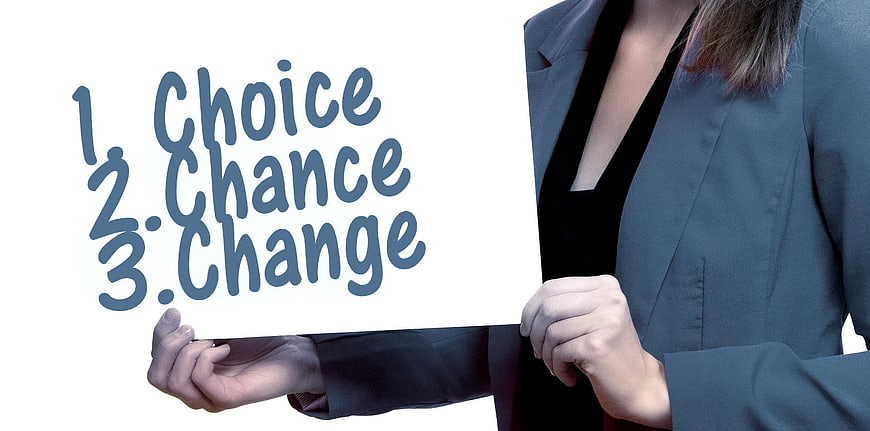 Businesswoman holding sign with choice, chance, change text