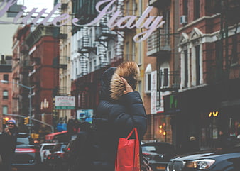 Woman in winter coat walking in Little Italy New York