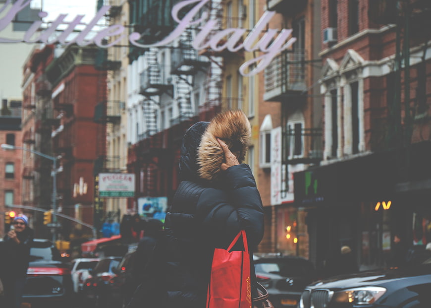 Woman in winter coat walking in Little Italy New York