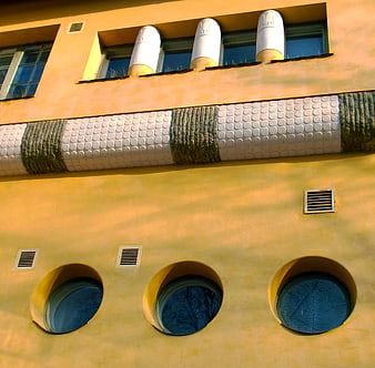 Colorful Art Nouveau Building Facade with Round Windows