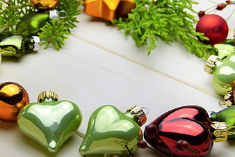 Christmas ornaments and fir branches on white wood background