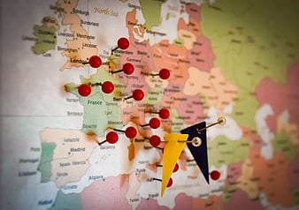 Red pins and flags marking destinations on a close-up map of Europe
