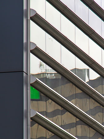 Modern Glass Building Facade with Diagonal Metal Louvers