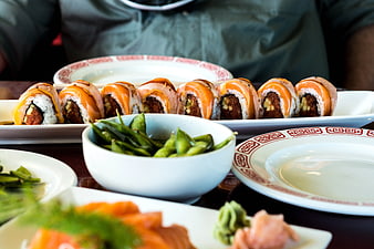 Sushi rolls and edamame on a restaurant table