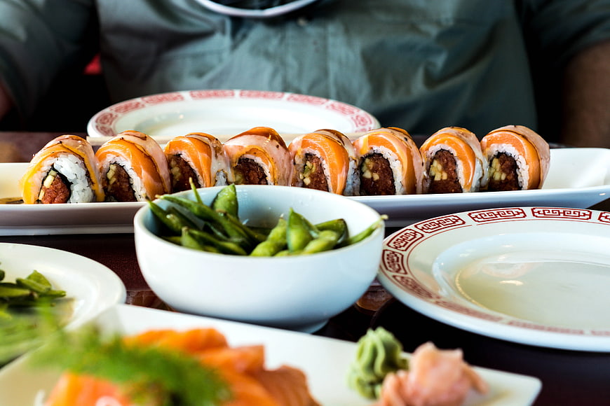 Sushi rolls and edamame on a restaurant table