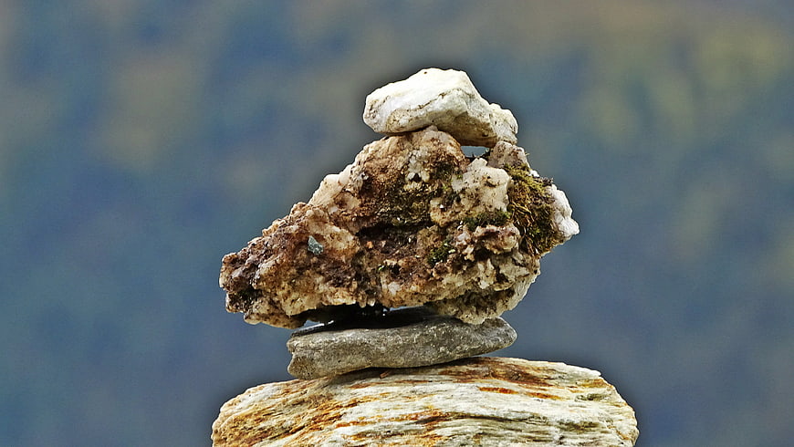 Balanced Rock Stack on Blurred Mountain Background