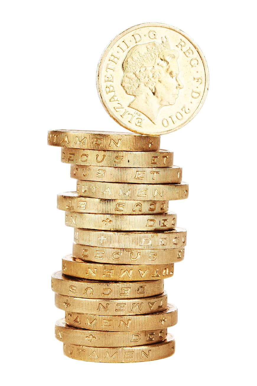 Stack of British Pound Coins with One Balanced on Top