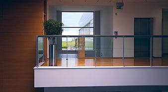 Modern office interior with glass railing and wooden floor
