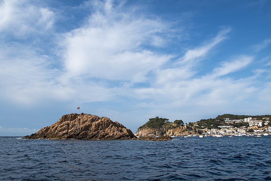 Rocky Island with Flag and Coastal Town in Tossa de Mar, Spain