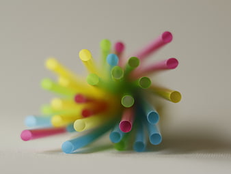 Colorful plastic straws close-up on white background