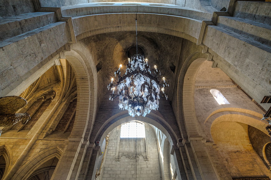 Grand Crystal Chandelier in Historic Stone Cathedral Interior