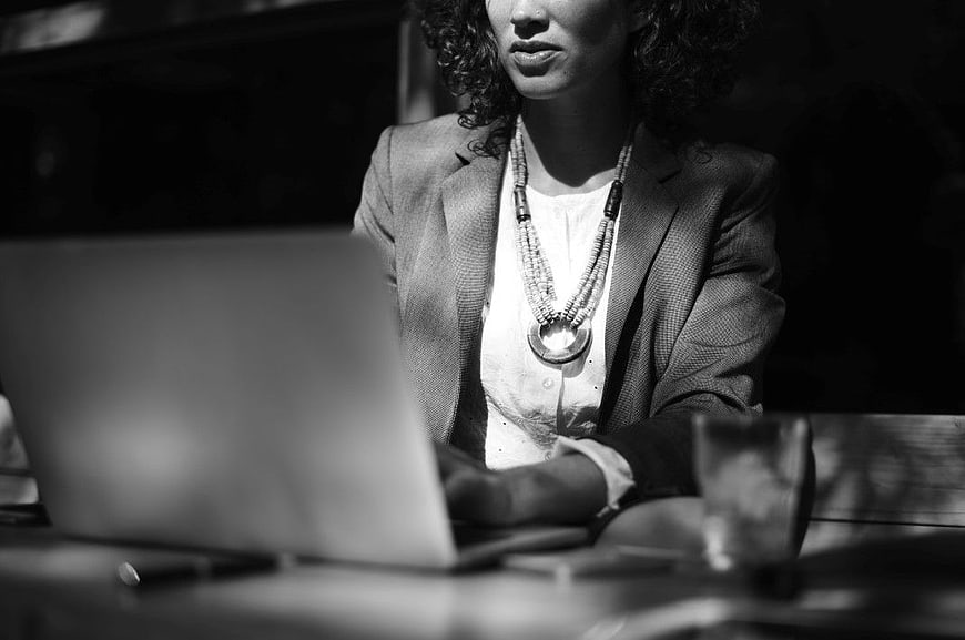 Professional Woman Working on Laptop in Black and White