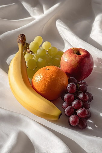 Fresh Fruit Arrangement on White Fabric Background