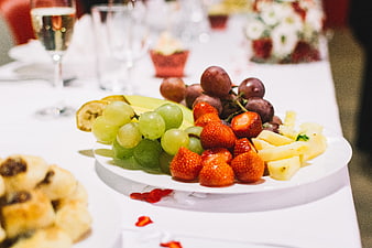 Fresh fruit platter with strawberries and grapes on a wedding table
