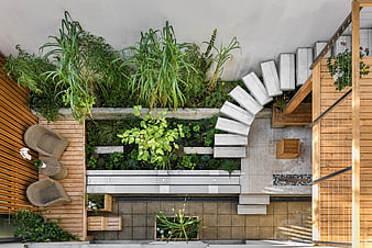 Aerial view of modern courtyard with wooden deck and spiral stairs