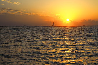 Golden Ocean Sunset With Distant Sailboats