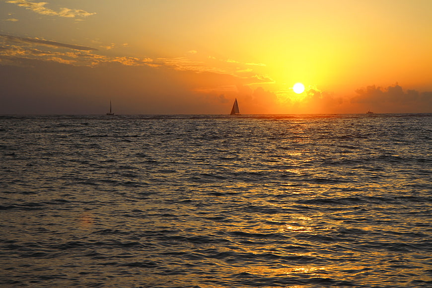 Golden Ocean Sunset With Distant Sailboats