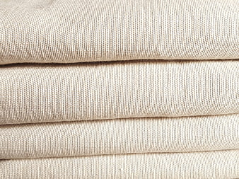 Close-up of folded beige linen fabric texture