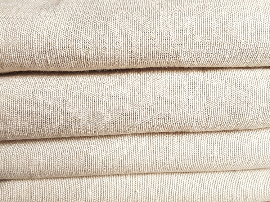 Close-up of folded beige linen fabric texture