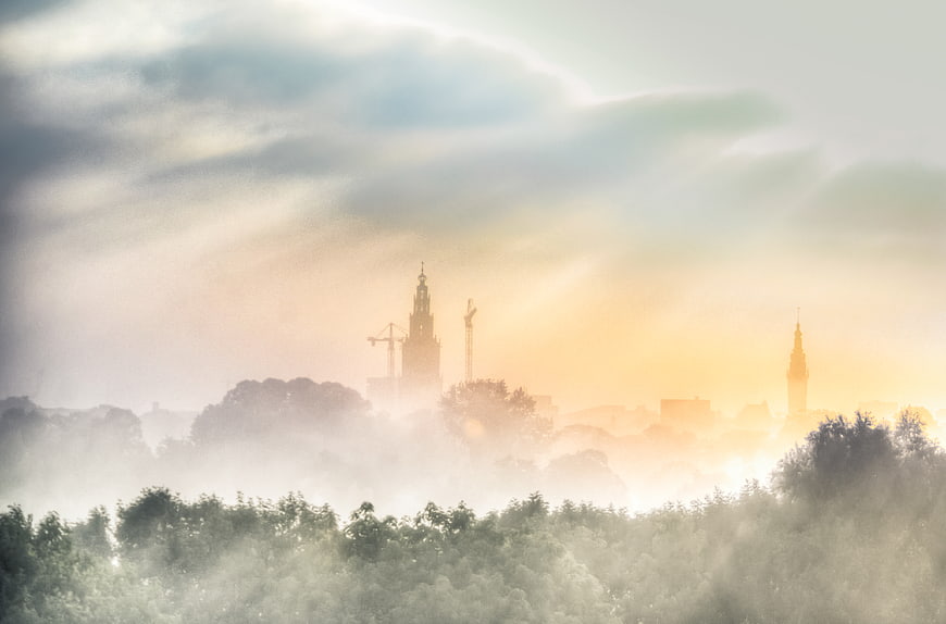 Misty Groningen Cityscape at Sunrise with Foggy Trees