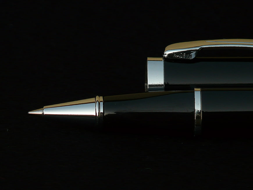 Luxury Black Ballpoint Pen With Gold Accents On Black Background