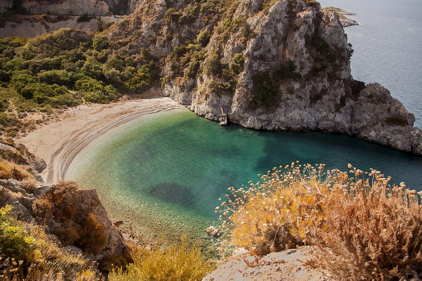 Secluded Mediterranean Cove with Turquoise Waters and Rocky Cliffs