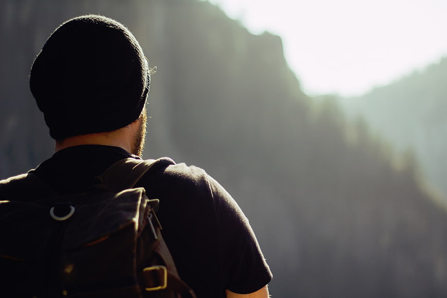 Hiker with Backpack Looking at Mountain Landscape