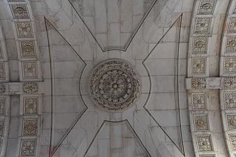 Intricate white marble ceiling with floral rosette and geometric patterns