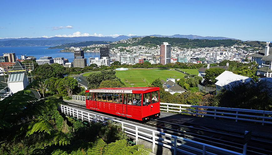 Red Wellington Cable Car Overlooking City And Harbour