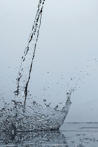 Dynamic Water Splash on Clean Blue Background