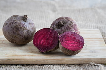 Fresh raw beetroots on wooden cutting board