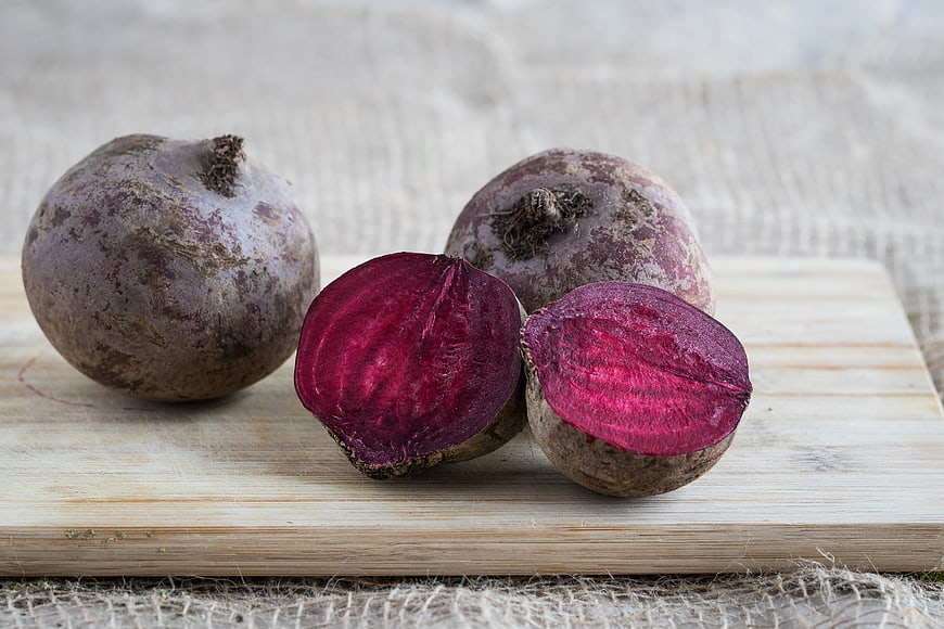 Fresh raw beetroots on wooden cutting board