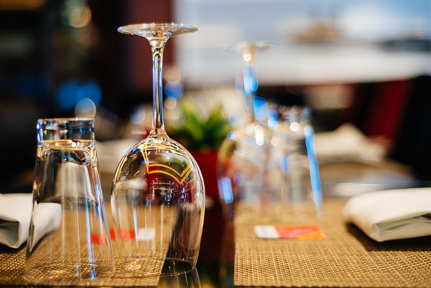 Upside down wine glass and water carafe on restaurant table