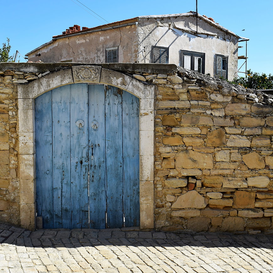 Weathered Blue Wooden Gate in Stone Wall Cyprus