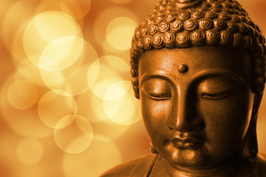 Golden Buddha Statue Head with Bokeh Background