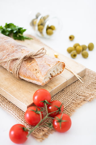 Rustic Baguette, Cherry Tomatoes, and Green Olives on Wooden Board