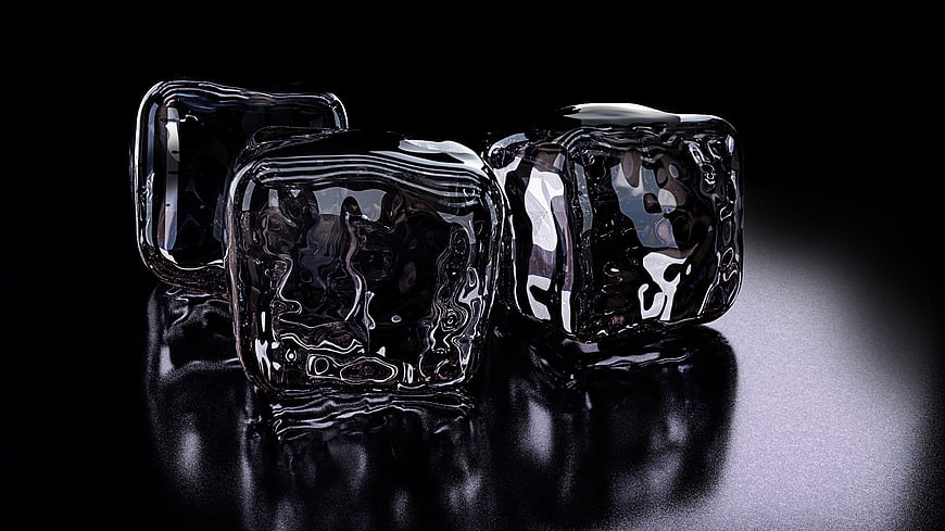 Three glossy black ice cubes on a reflective dark surface