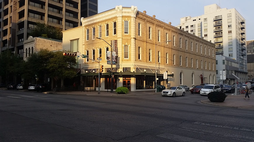 Historic yellow brick building on city street corner