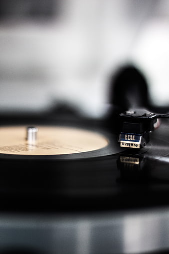 Close-up of a vinyl record player tonearm and needle