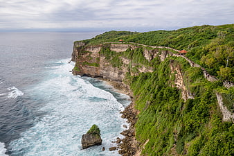 Aerial View of Lush Green Cliffs and Turquoise Ocean in Bali