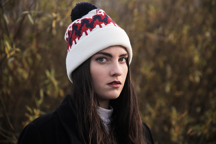 Woman in Patterned Beanie Looking at Camera
