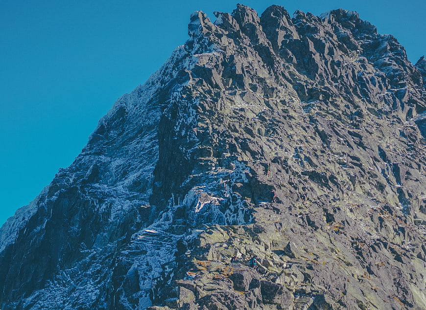Rock Climbers Scaling Rugged Mountain Peak