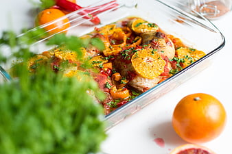 Baked Chicken Thighs with Oranges and Herbs in Glass Dish